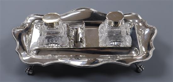 A George V silver two bottled inkstand and a late Victorian silver stamp box (a.f).